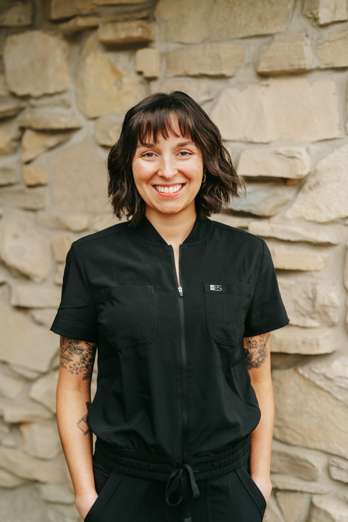 Headshot of Kristy Anderson, Dental Assistant with straight dark hair poses confidently in a modern dental office